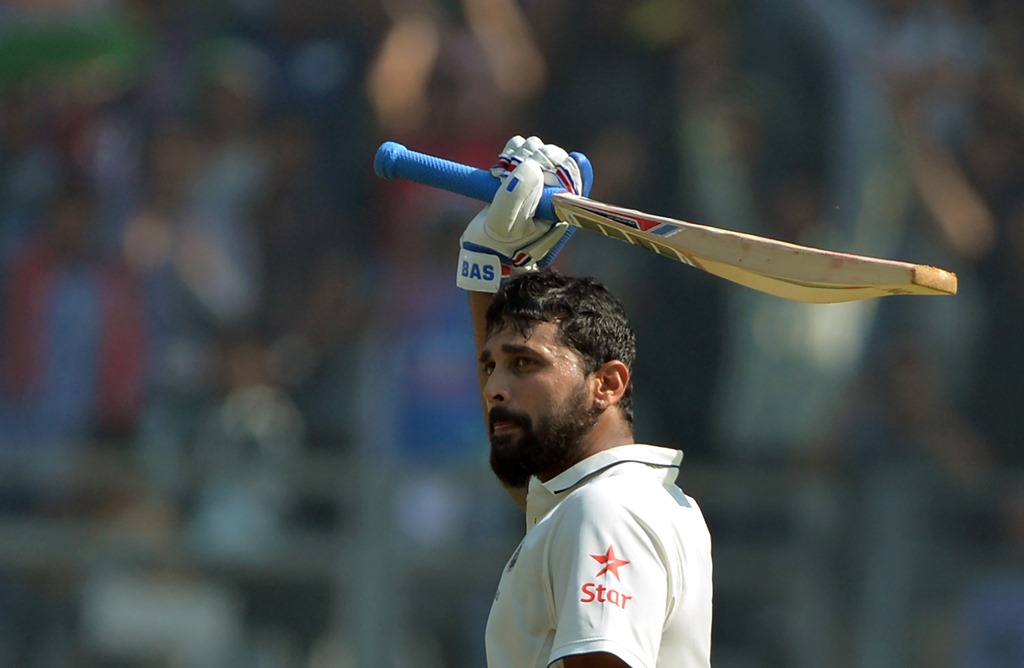 India's Murali Vijay celebrates after scoring a century on the third day of the fourth Test match between India and England at the Wankhede stadium in Mumbai on December 10, 2016. GETTYOUT / AFP / Punit PARANJPE 