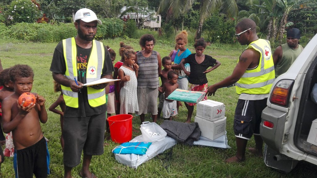 Solomon Islands Red Cross Auki Branch officers distribute aid to families affected by Saturday's earthquake, at Malaita province on the Solomon Islands in a handout photo December 9, 2016. Solomon Islands Red Cross/Handout via REUTERS
