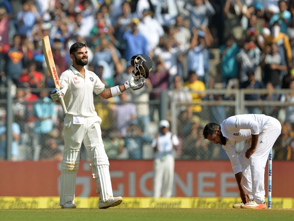 India's captain Virat Kohli celebrates after scoring a double century (200 runs) on the fourth day of the fourth Test cricket match between India and England at the Wankhede stadium in Mumbai on December 11, 2016. GETTYOUT / AFP / PUNlT PARANJPE /