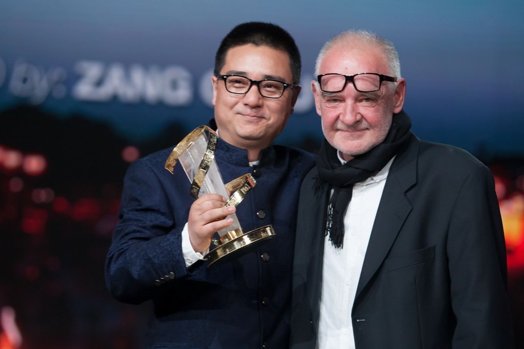 Chinese director Zang Qiwu (L) receives the Golden star for the film 