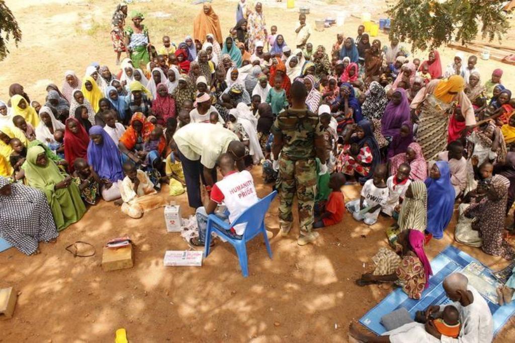 People who were rescued after being held captive by Boko Haram, sit as they wait for medical treatment at a camp near Mubi, northeast Nigeria October 29, 2015. REUTERS/Stringer