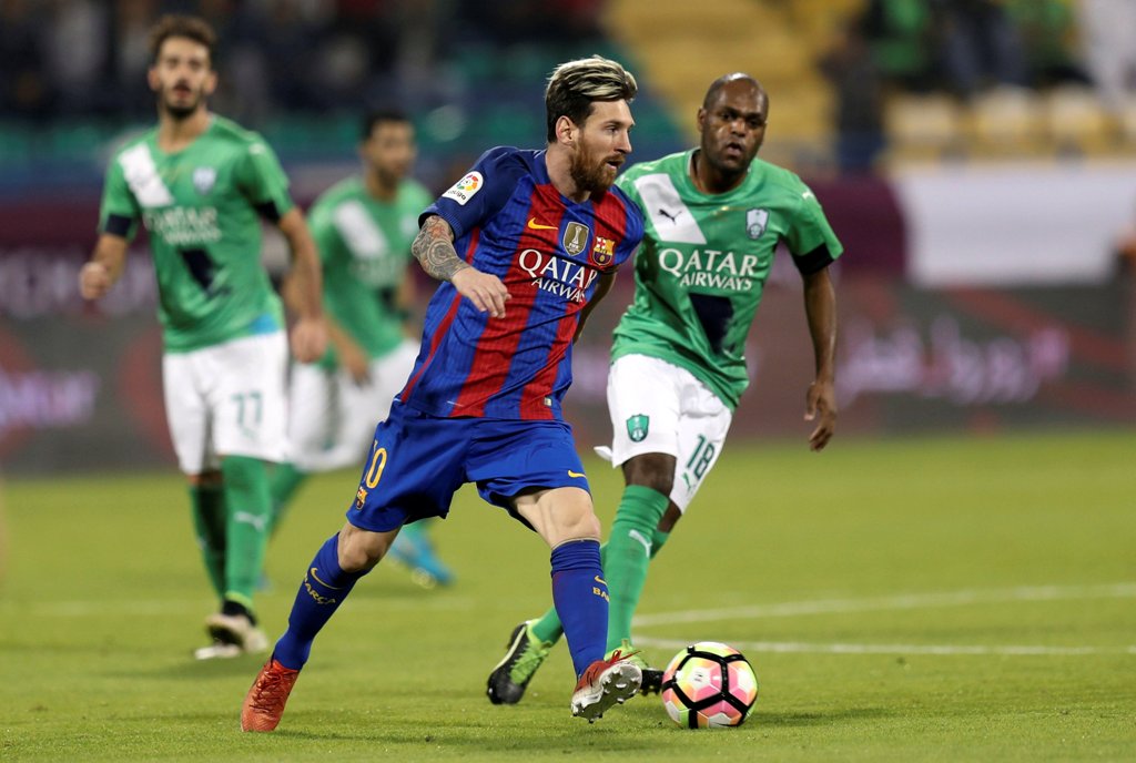 Barcelona's Lionel Messi fights for the ball with Saudi Arabia's Al-Ahli Luiz Carlos. REUTERS/Ibraheem Al Omari
