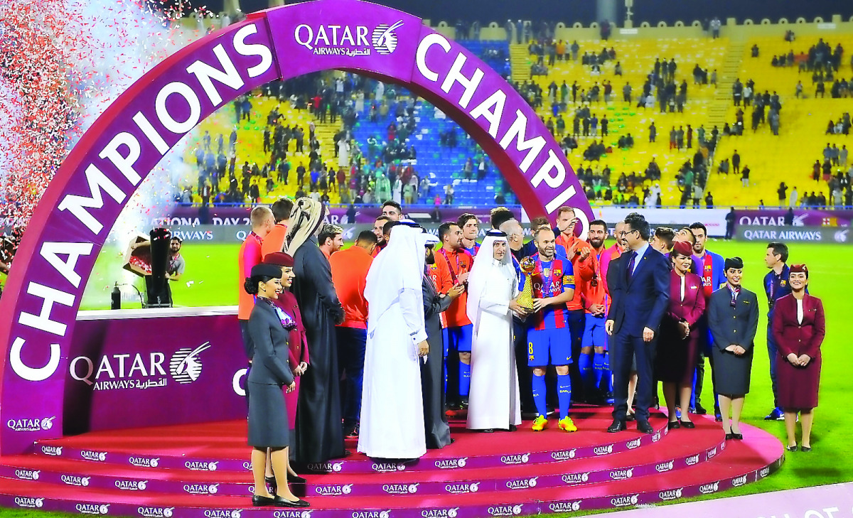 Akbar Al Baker, Group Chief Executive of Qatar Airways, presenting 18 carat gold cup, specially commissioned for the game, to FC Barcelona captain Andres Iniesta at Al Gharafa stadium yesterday. Barcelona defeated Al Ahli of Saudi Arabia 5-3 in the friend