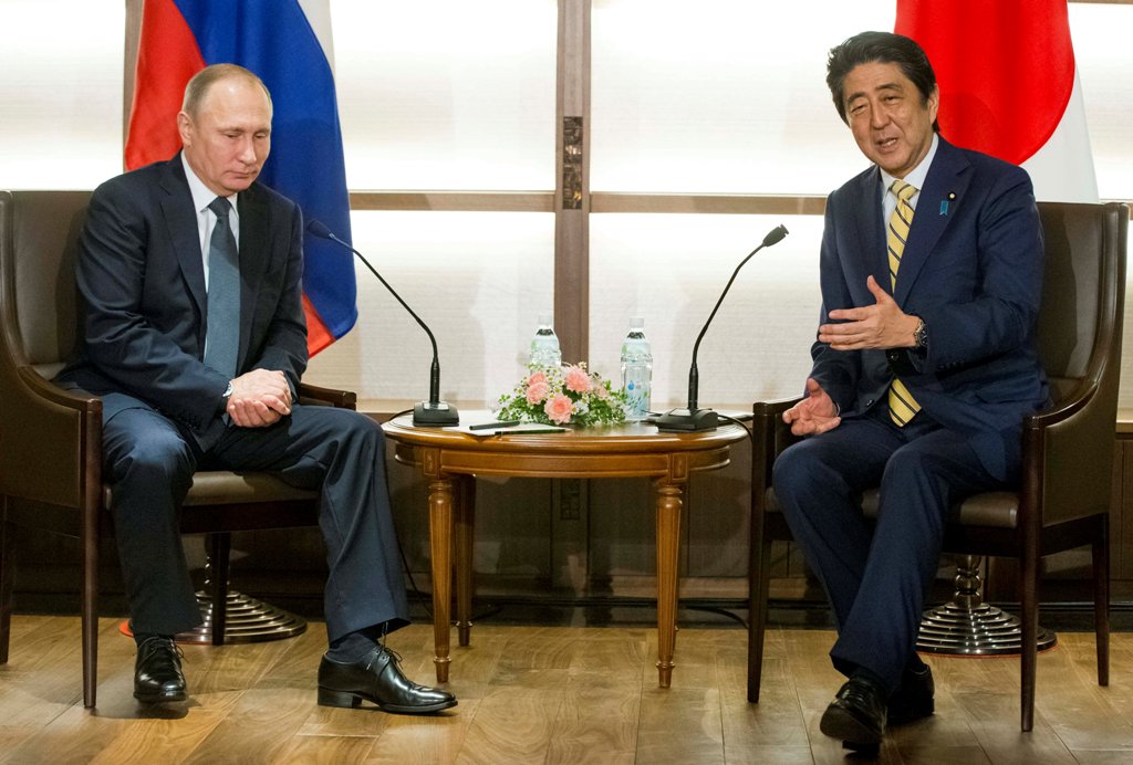 Japanese Prime Minister Shinzo Abe gestures while speaking to Russian President Vladimir Putin during their meeting at a hot springs resort in Nagato, Japan, December 15, 2016. REUTERS/Alexander Zemlianichenko/Pool
