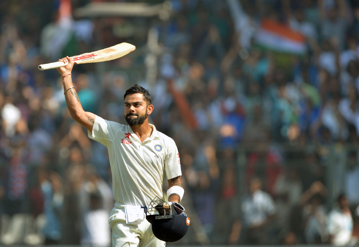 Virat Kohli greeting the crowd as he walks back towards the pavilion after his dismissal on the fourth day of the fourth Test cricket match between India and England at the Wankhede stadium in Mumbai. (AFP / PUNlT PARANJPE)