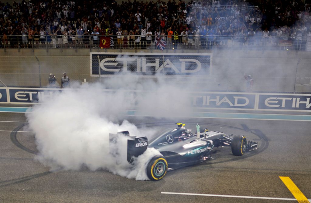 (FILES) This file photo taken on November 27, 2016 shows Mercedes AMG Petronas F1 Team's German driver Nico Rosberg celebrating at the end of the Abu Dhabi Formula One Grand Prix at the Yas Marina circuit.  AFP / MOHAMMED AL-SHAIKH
