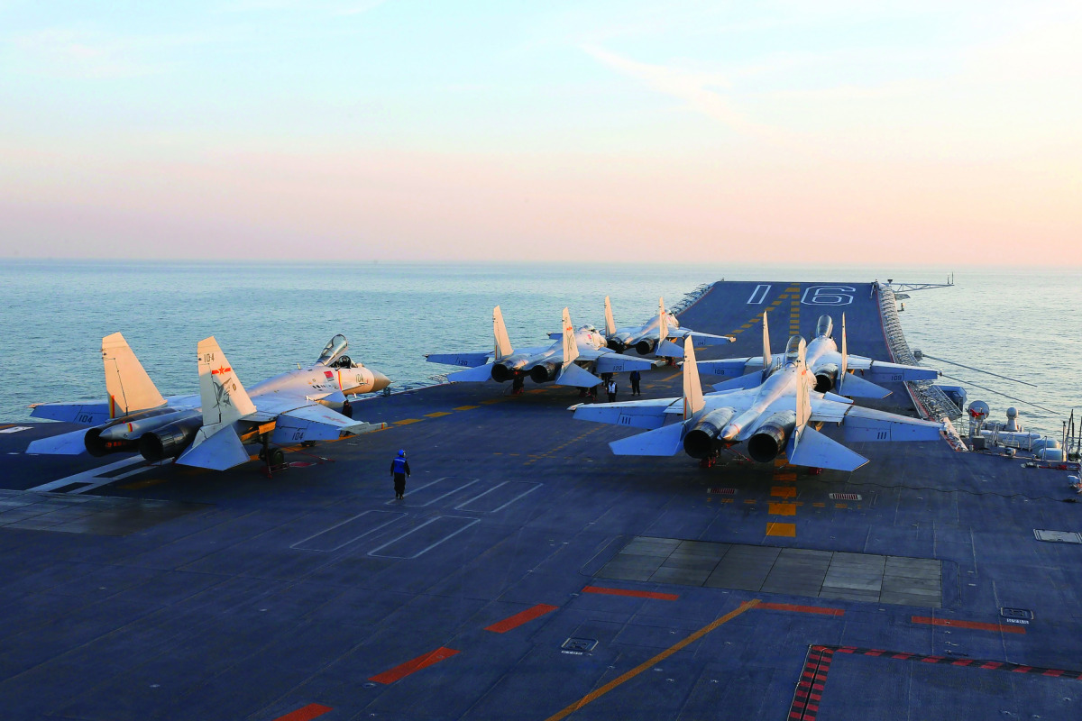 Chinese J-15 fighter jets waiting on the deck of the Liaoning aircraft carrier during military drills in the Bohai Sea. 