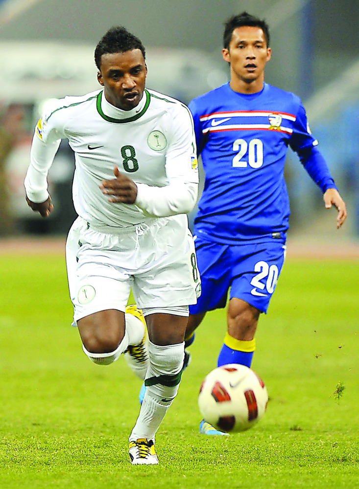 Saudi Arabia's Mohammed Noor (left) running with the ball during a football match against Thailand at King Fahad Stadium, in Riyadh, Saudi Arabia in this file photo of November 11, 2011. 