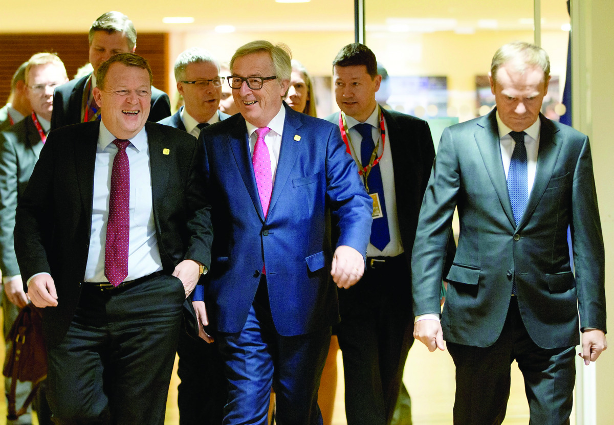 Danish Prime Minister Lars Lokke Rasmussen (left) walks with European Commission President Jean-Claude Juncker (centre) and European Council President Donald Tusk to a meeting regarding Europol in Brussels.