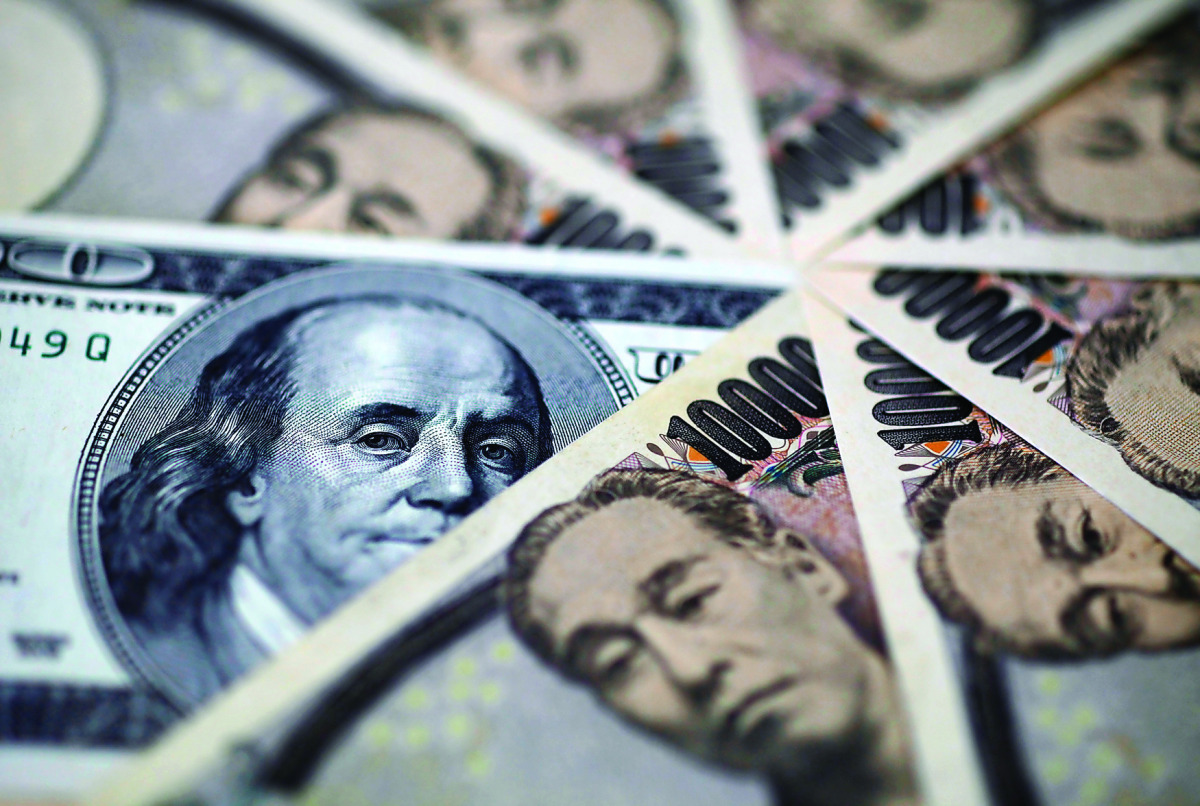 A US one-hundred dollar bill and Japanese 10,000 yen notes are spread in Tokyo, Japan.