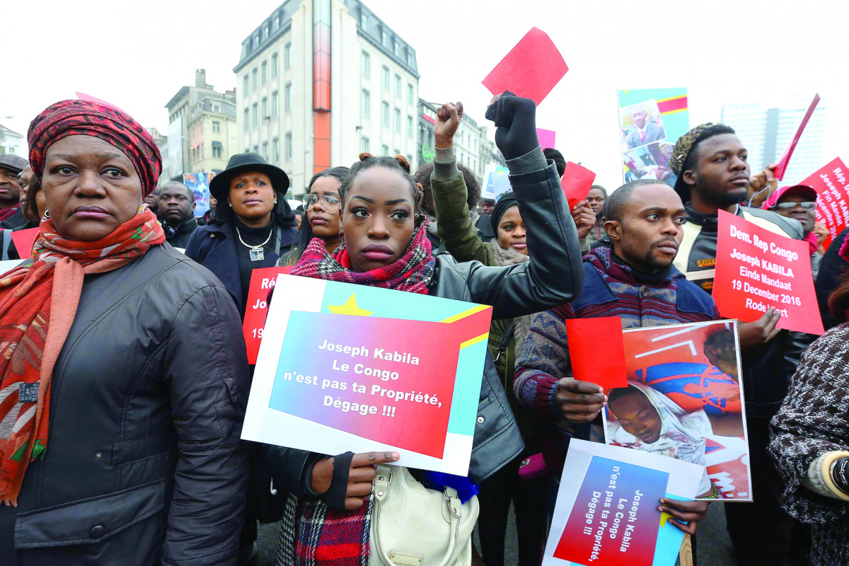 Members of the Congolese community in Belgium demonstrate in Brussels yesterday to ask the departure of Congo's President Joseph Kabila at the end of its mandate tomorrow.