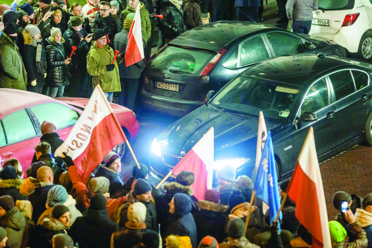 People block the exit from Polish Parliament during an anti-government demonstration in Warsaw, yesterday.