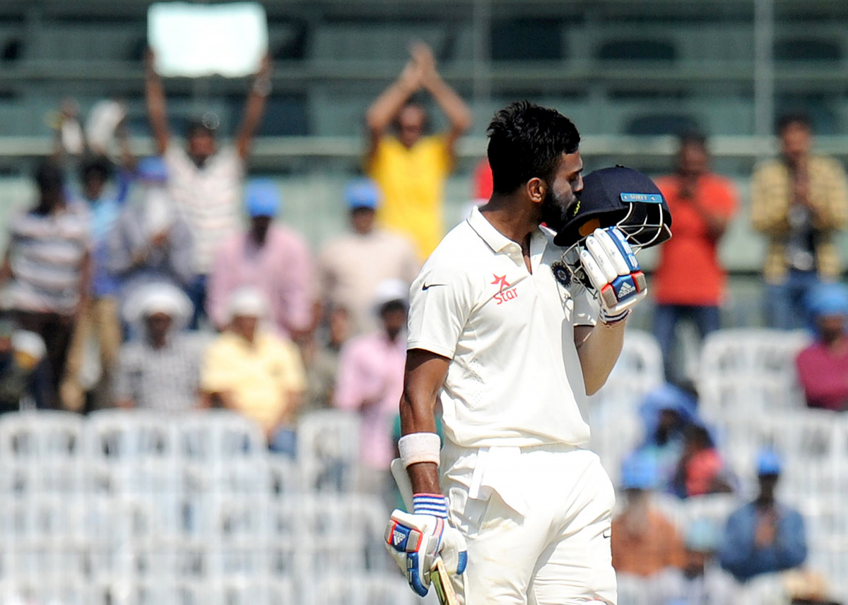 India's Lokesh Rahul kisses his helmet as he celebrates after scoring a century (100 runs) during the third day of the fifth and final Test cricket match between India and England at The M.A. Chidambaram Stadium in Chennai on December 18, 2016. (AFP / ARU