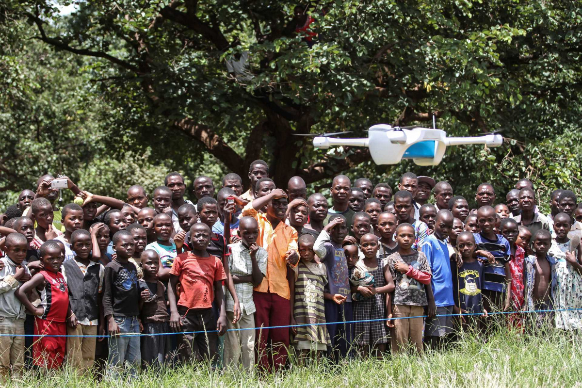 Children in Malawi look on during a community demonstration of drones in Lilongwe, Malawi, on March 12, 2016. Photos by UNICEF