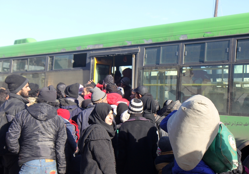 ALEPPO, SYRIA - DECEMBER 18 : Syrians wait to be evacuated from the east part of Aleppo that had been under siege by Assad Regime forces and its supporter foreign terrorist groups at a crossing point at Amiriyah district of Aleppo in Syria on December 18,