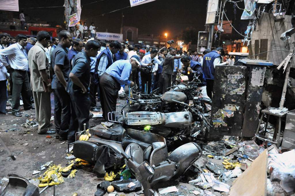 (FILES) This file photograph taken on February 21, 2013, shows Indian police and investigators at the site of a bomb blast at Dilshuk Nagar in Hyderabad. An Indian court on December 19, 2016, has sentenced two alleged leaders of a homegrown militant group