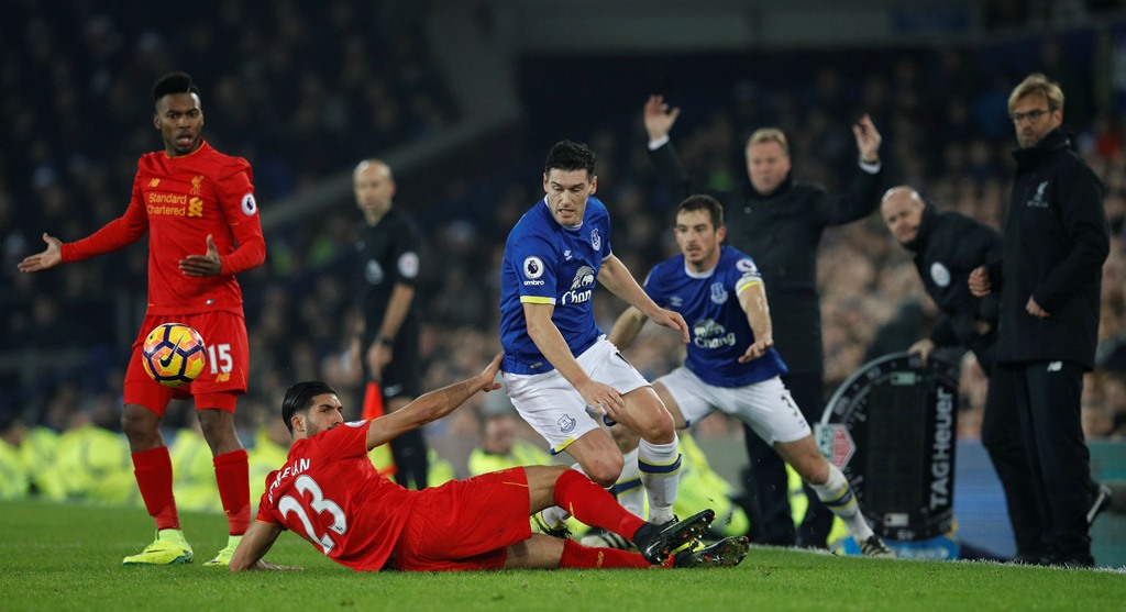 Liverpool's Emre Can and Daniel Sturridge in action with Everton's Gareth Barry as Everton manager Ronald Koeman and Liverpool manager Juergen Klopp react. Reuters / Phil Noble 