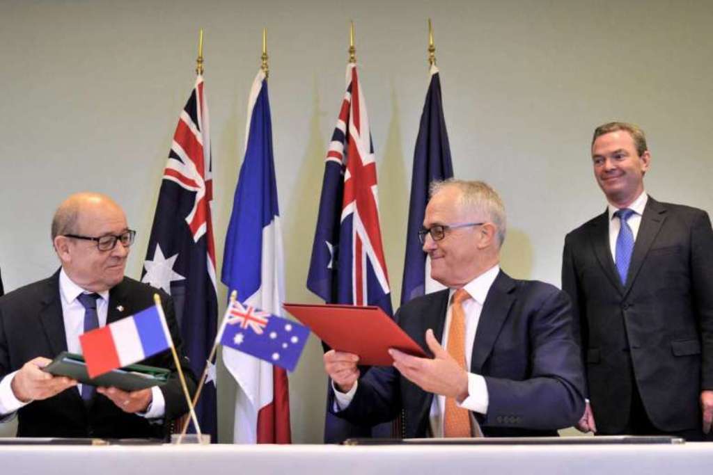 Australian Prime Minister Malcolm Turnbull (right) and French Minister for Defence Jean-Yves Le Drian (left) attending the signing of the Inter-Governmental Agreement.PHOTO: REUTERS.