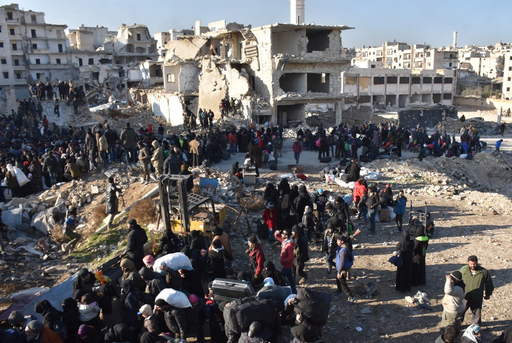 Civilians from East Aleppo, which was under siege by Assad regime forces and its supporter foreign terrorist groups, wait for their evacuation at Amerriye region of Aleppo, Syria on December 20, 2016. ( Mustafa Sultan - Anadolu Agency )