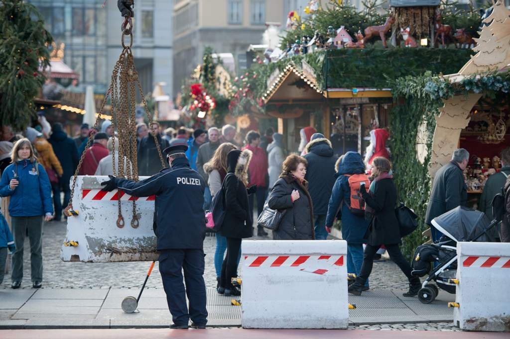 A policeman places concrete elements in front of the 