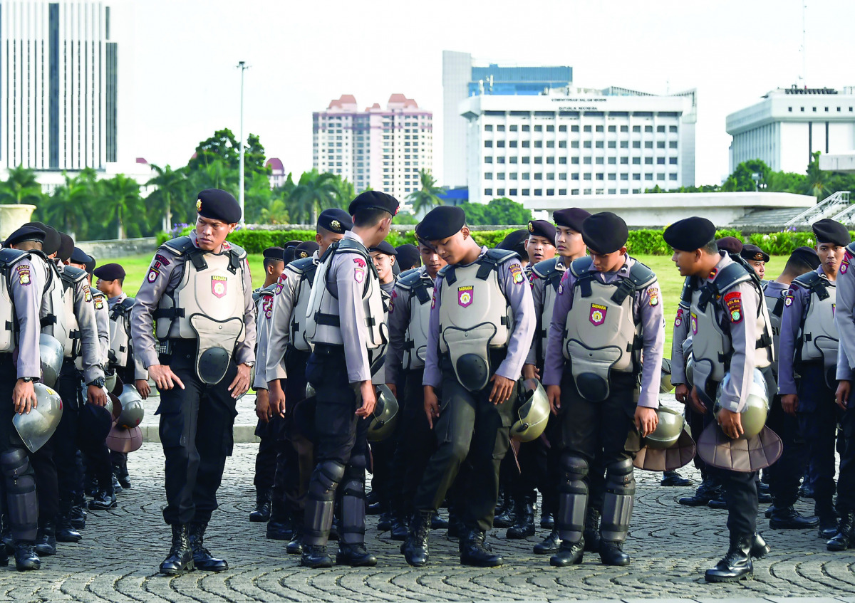Indonesian anti-riot police take part in a roll call in Jakarta,  yesterday, as part of efforts to secure holidays celebrations.