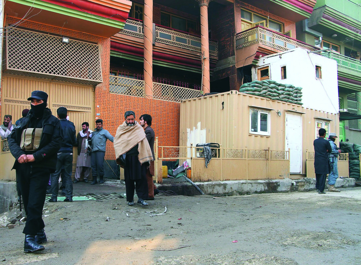 Afghan security officials at the site of Taliban attack in Kabul, yesterday.