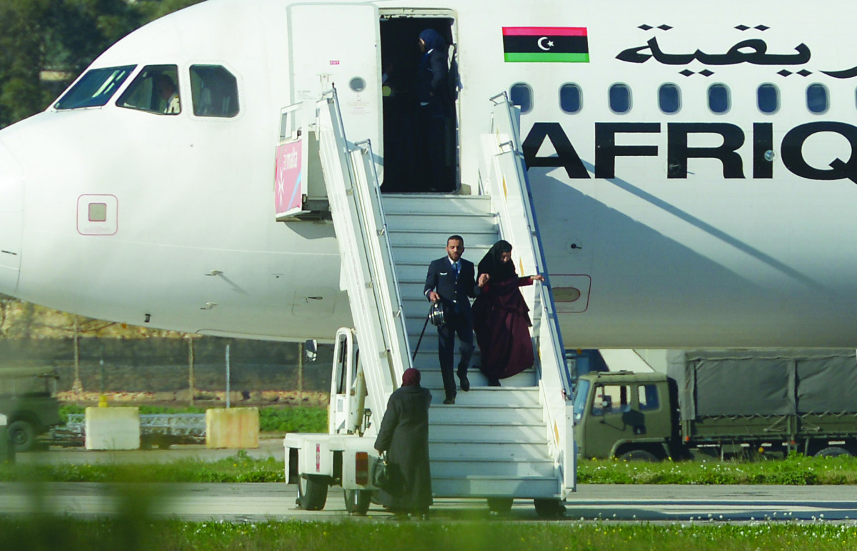 A crew member helping a hostage to disembark from the Afriqiyah Airways A320 after it was hijacked from Libya, in Valletta, Malta, yesterday.