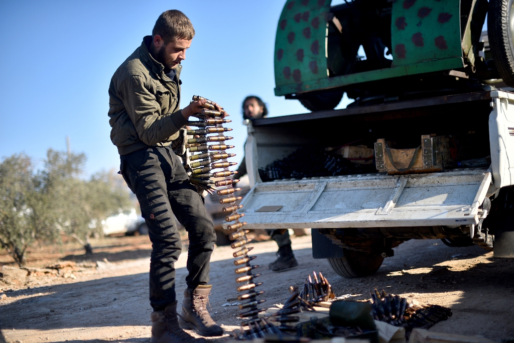 Members of Free Syrian Army carry bullets as they advance to al-Bab town of Aleppo during the 