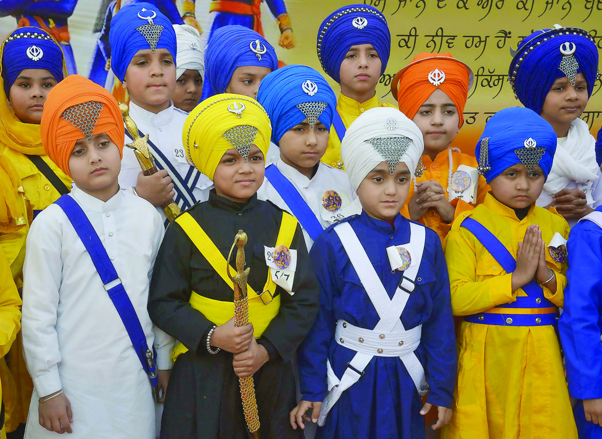 Young Indian Sikhs wait for the judging of a turban tying competition at a school in Amritsar on December 25, 2016. The competition was organized by the Sikh organization, Akal Purakh Ki Fauj to promote greater awareness of the turban. The Turban is close