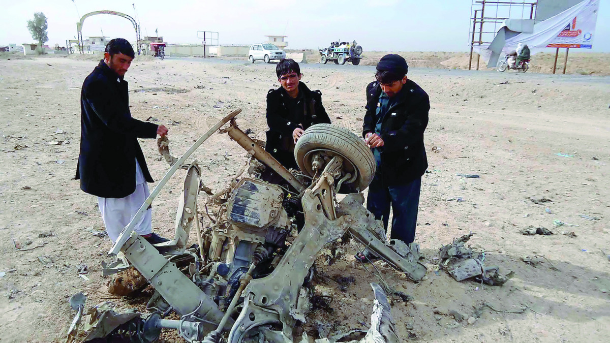A wreckage of a car is seen after a bomb targeting the convoy of deputy provincial police chief of southern Helmand province exploded in Helmand district, Afghanistan, yesterday.