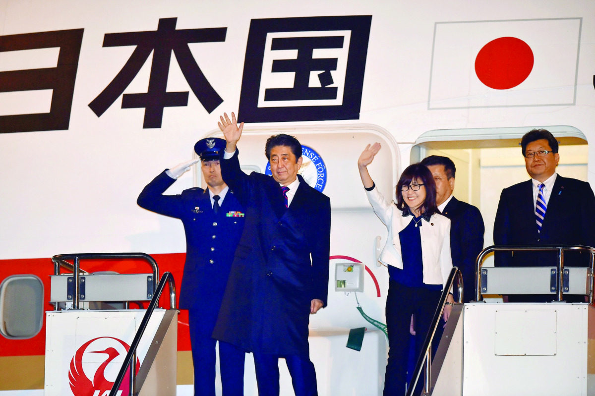 Japan's Prime Minister Shinzo Abe and Defence Minister Tomomi Inada (third left) wave as they depart for Hawaii at Tokyo's Haneda Airport, yesterday.
