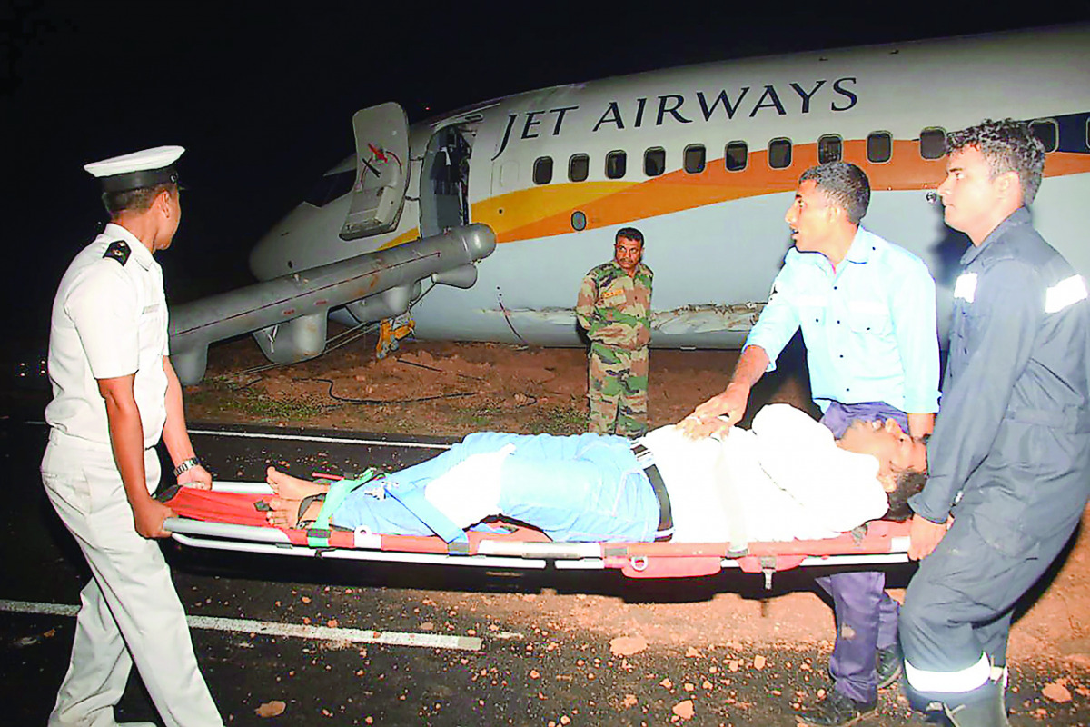 Rescue and Navy personnel moving an injured passenger away from a damaged Jet Airways Boeing 737 after it skidded off the runway at the Goa Airport in Dabolim, yesterday.