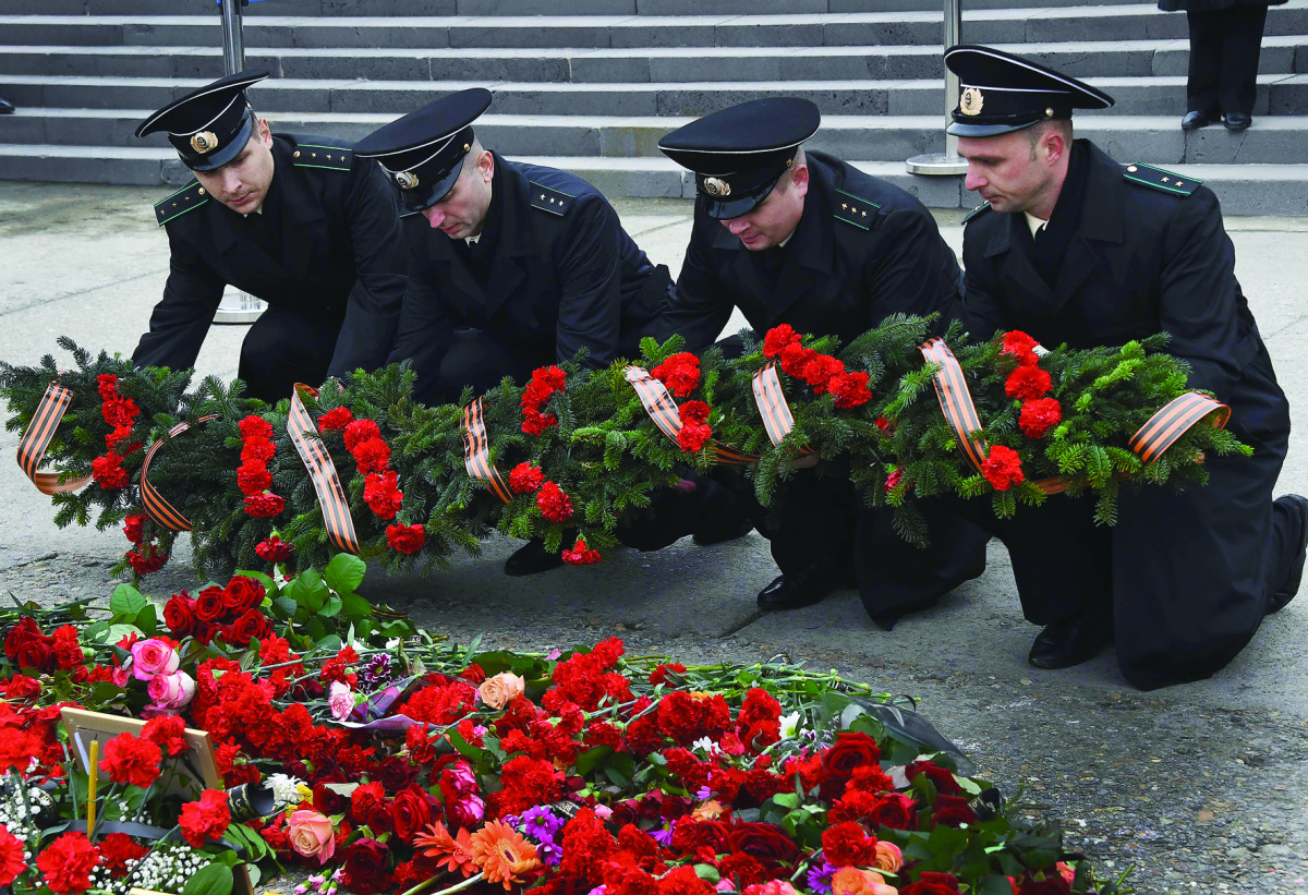 Russia's coast guard officers lay a wreath at a makeshift memorial in Sochi, yesterday.
