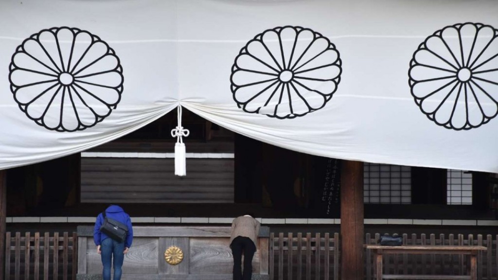 Visitors pray at the Yasukuni Shrine, which honours millions of Japanese war dead but also senior military and political figures convicted of war crimes after the second world war. Photo: AFP