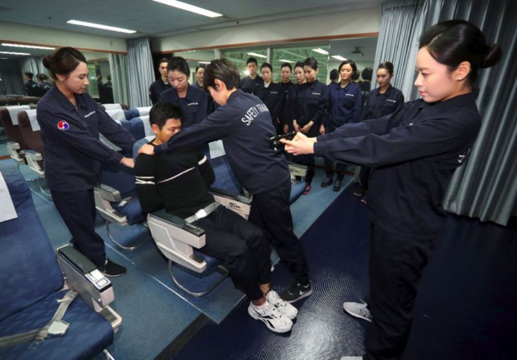 Korean Air is training crew to use more force to restrain violent passengers after an incident involving an unurly passenger prompted complaints (AFP Photo/STR).