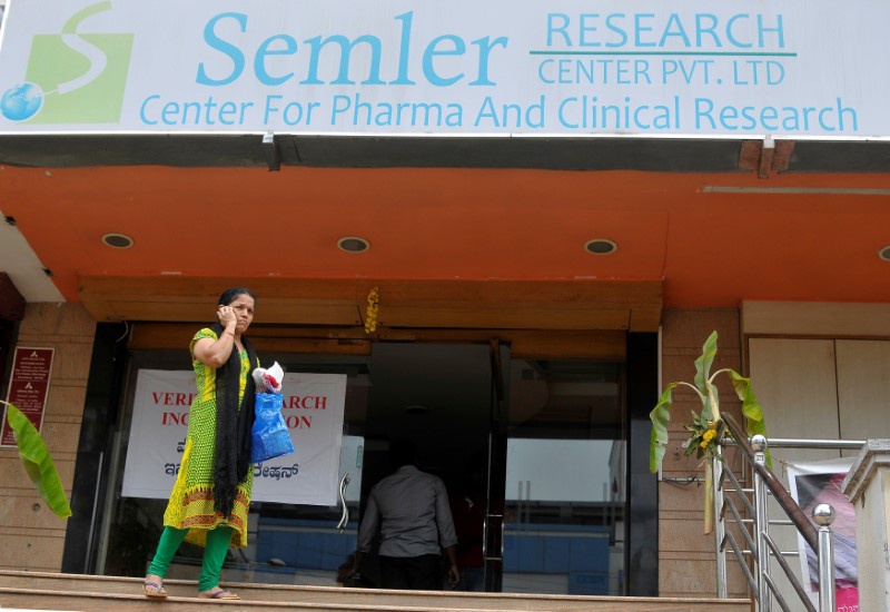 A woman talks on a mobile phone as she walks past the closed research facility of Semler Research Centre in Bengaluru, India, October 13, 2016. REUTERS/Abhishek N. Chinnappa
