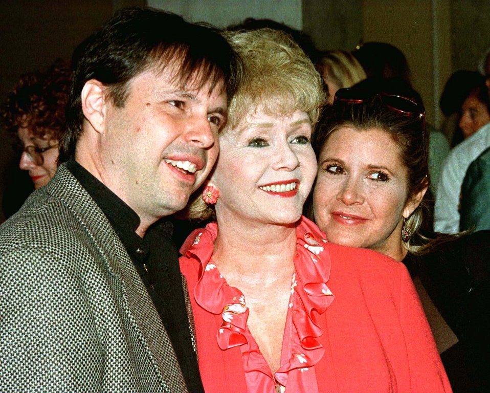 Actress Debbie Reynolds (C) and son, filmmaker Todd Fisher, and daughter, screenwriter Carrie Fisher, arrive at a luncheon hosted by the American Film Institute September 17, 1998. REUTERS/File Photo 