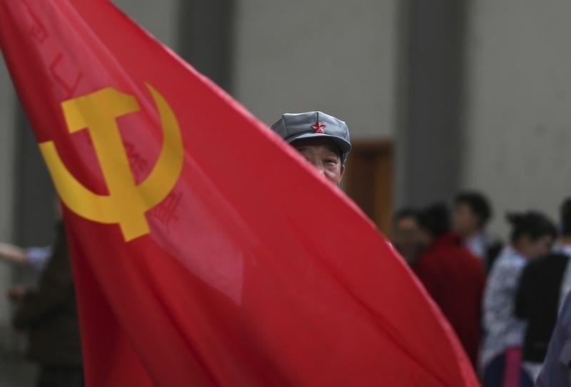 A participant waves a  flag as he waits backstage before his performance at a line dancing competition in Kunming, Yunnan province, January 31, 2015 (REUTERS)