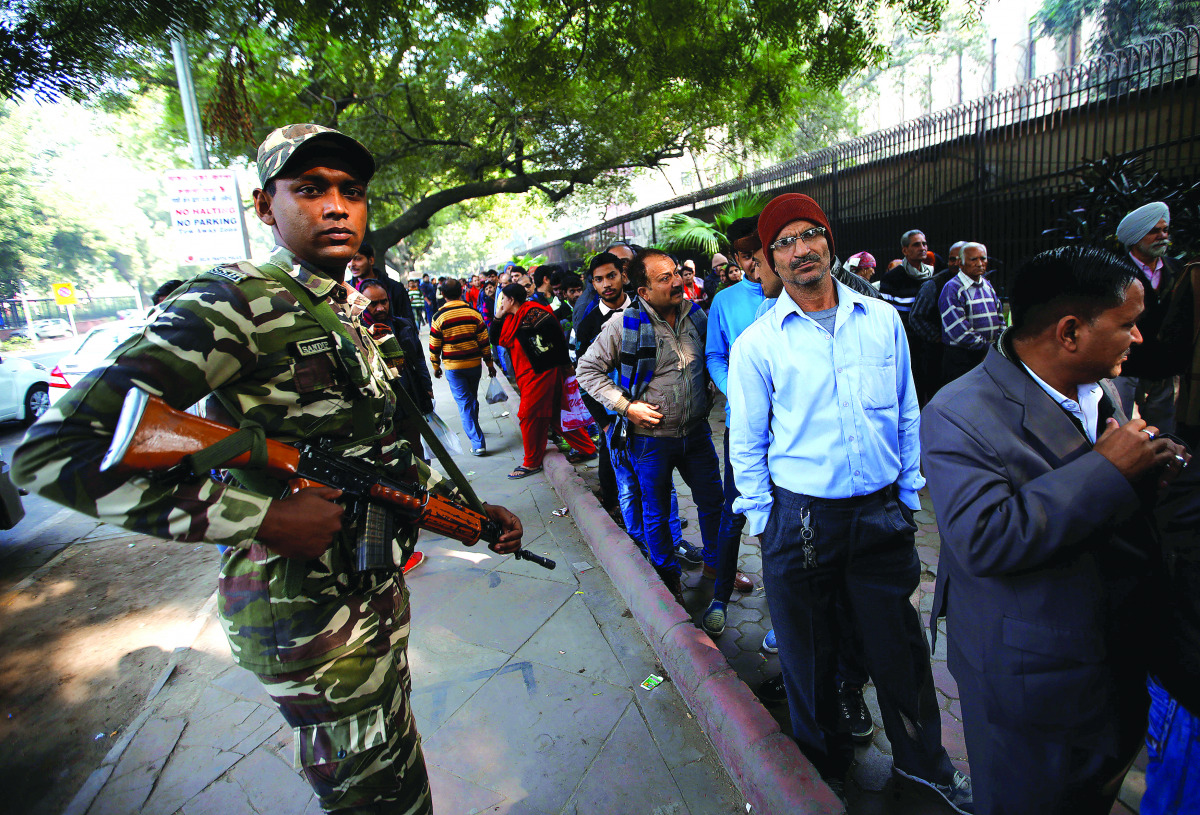 People queue outside the Reserve Bank of India to exchange their old high denomination bank notes, in New Delhi, yesterday.