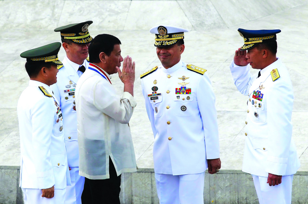 President Rodrigo Duterte returns the salute of a military officer as he leads the death anniversary celebration of Filipino national hero Dr Jose Rizal in Manila, yesterday.
