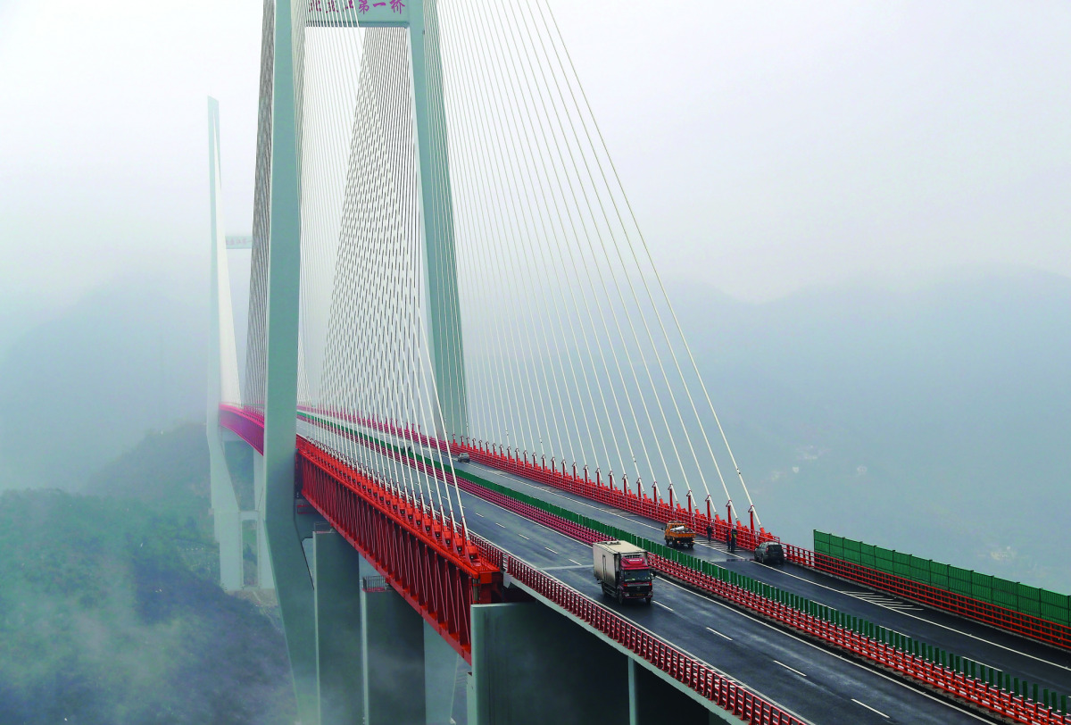 Vehicles making their way through the Beipanjiang Bridge, near Bijie in southwest China's Guizhou province.