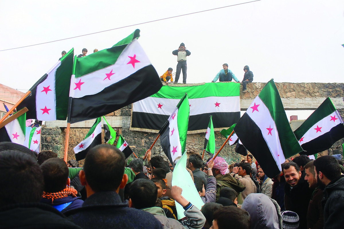 Syrians stage a protest against Assad Regime after Friday prayer at the Etarib district of Aleppo, Syria on December 30, 2016. (Ahmed al Ahmed - Anadolu Agency)