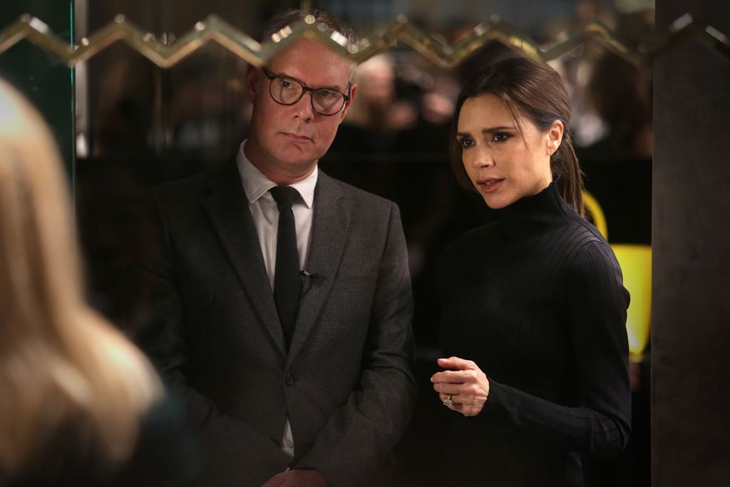 (FILES) This file photo taken on March 18, 2016 shows Fashion designer Victoria Beckham (R), being interviewed in her new fashion store which is opening at the Landmark in the Central district of Hong Kong. AFP / ISAAC LAWRENCE