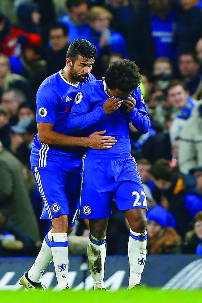 Chelsea's Willian (right) is consoled by Diego Costa after scoring a goal against Stoke City during their Premier League match at Stamford Bridge Stadium in London, in England yesterday.