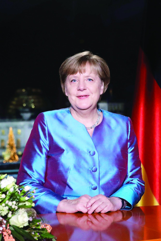 German Chancellor Angela Merkel poses for a photograph after the recording of her annual New Year's speech at the Chancellery in Berlin, yesterday.