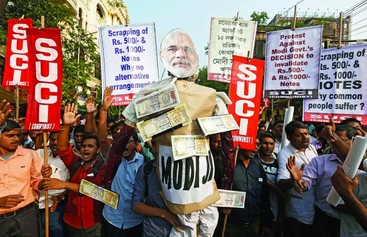 Activists of the Socialist Unity Centre of India (SUCI) shouting slogans as they carry an effigy of Prime Minister Narendra Modi during a protest against government's decision of demonetisation.