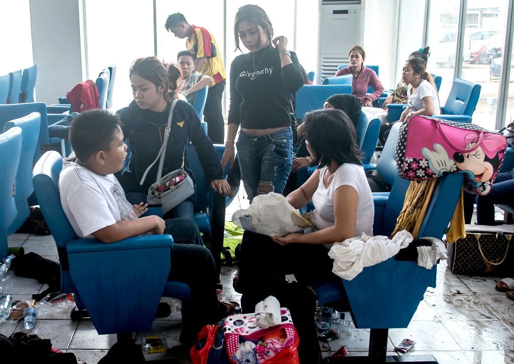 This photo taken on January 1, 2017 shows survivors gathering at a resting room after they were rescued from the burning passenger boat which was ferrying around 200 people off the coast of Jakarta to Tidung island, a tourist destination 50 kilometres (30