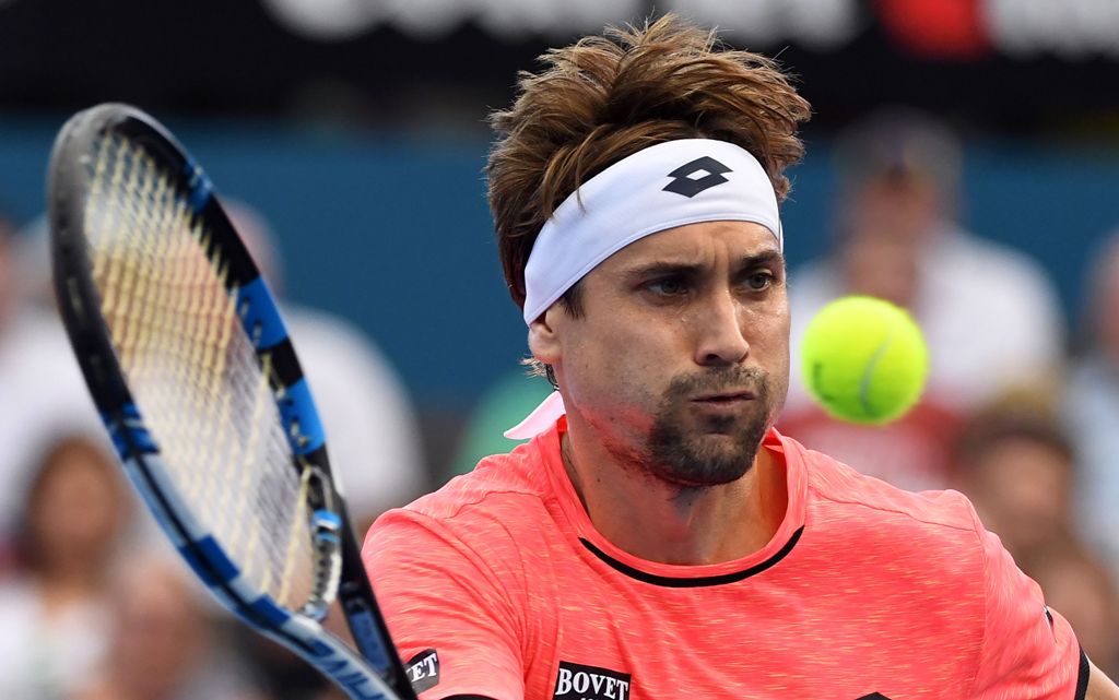 David Ferrer of Spain hits a return against Australia's Bernard Tomic in the men's first round at the Brisbane International tennis tournament in Brisbane on January 2, 2017. AFP / SAEED KHAN