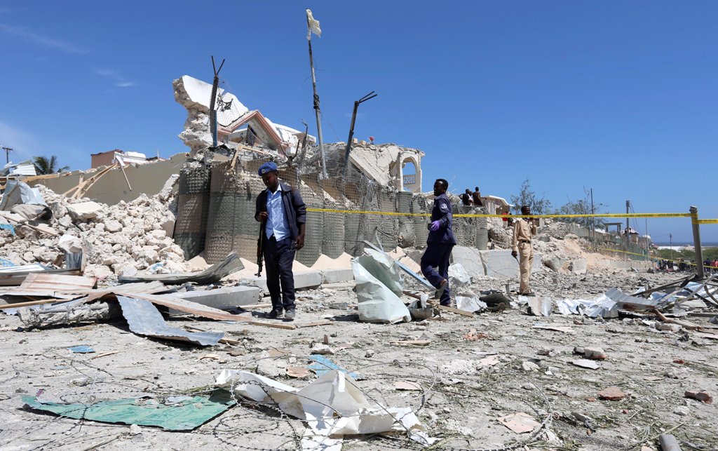 Somali policemen walk through the rubble after a suicide attack at a checkpoint outside the main base of an African Union peacekeeping force in the Somali capital Mogadishu, January 2, 2017. REUTERS/Feisal Omar
