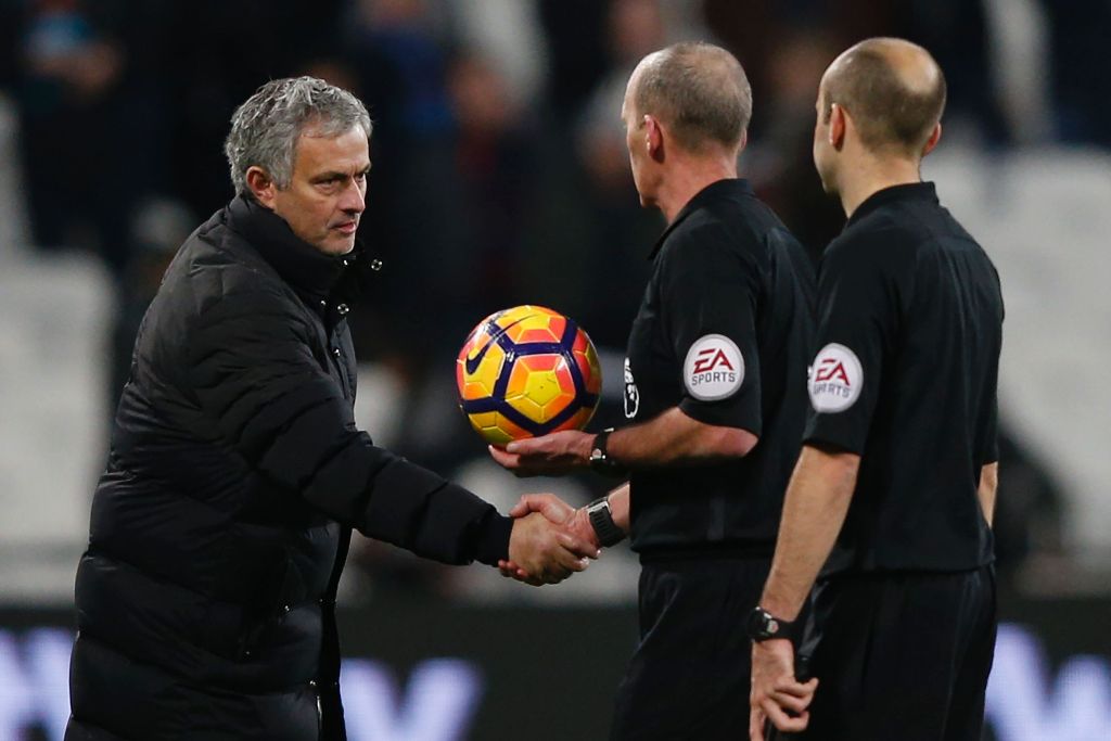 Manchester United's Portuguese manager Jose Mourinho (L) shakes hands with referee Mike Dean on the pitch after the English Premier League football match between West Ham United and Manchester United at The London Stadium, in east London on January 2, 201